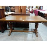 An oak refectory style dining table on carved bulbous supports. 61' long
