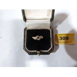 A six stone diamond crossover ring. In gold marked 18ct. Size P½. 2g gross