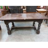 A 17th century style joined oak refectory table, the cleated three plank top on heavy turned legs.