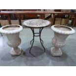 A metal patio table and a pair of plastic campana urns