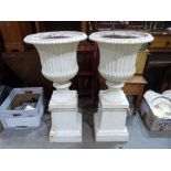 A pair of Victorian cast iron campana urns on square socle bases. 40' high
