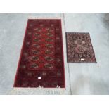 A red ground rug 53' x 27' and a prayer mat