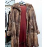 A vintage fur coat with a box of fur collars
