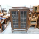 An oak glazed bookcase. 36' wide