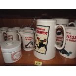 11 Guinness pub water jugs; a Guinness table lamp and a Carlton Ware cheese jar (A.F.)