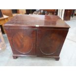 A 19th century mahogany chest, the pair doors enclosing two flights of six drawers, raised on