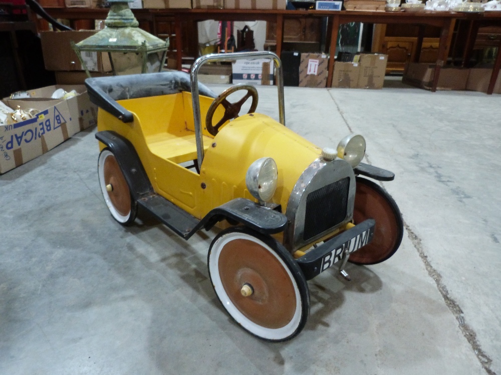 A tinplate pedal car after the childrens' television character 'Brum'