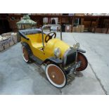 A tinplate pedal car after the childrens' television character 'Brum'