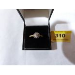 A nine stone diamond cluster ring. In gold marked 18. Size U. 3.5g gross
