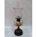 A Victorian oillamp with clear glass fount