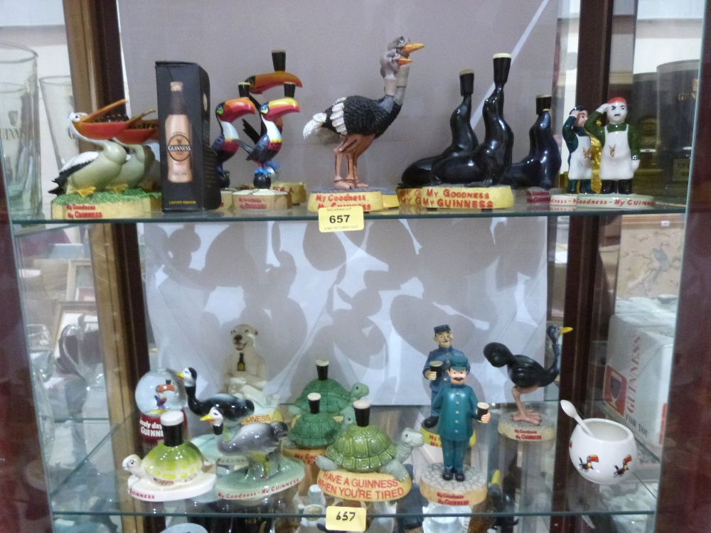 A collection of Guinness themed resinous and ceramic figures to include some Carlton Ware examples