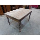 A Victorian pine kitchen table on turned legs. 52' long (Formerly with frieze drawer, now lacking