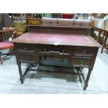 A 1930s oak writing table with leather inlet top on bobbin turned legs. 45' wide