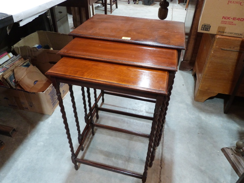 A nest of three mahogany occasional tables on barleytwist spider legs. 28½' high