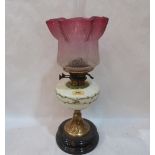 A Victorian oillamp with milch-glass fount painted with flowers and ruby flashed acid etched