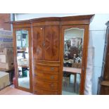 A fine quality Victorian bow-breakfront triple wardrobe with cupboard enclosed by a pair of doors,