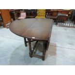 An oak dropleaf dining table