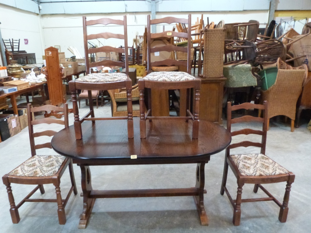 An extending dining table and set of six ladderback chairs
