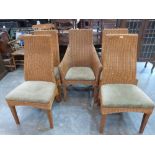 A set of five wicker dining chairs