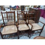 A set of six oak Lancashire type spindle back chairs with rush seats, the set to include two
