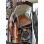 A collection of vintage handbags and a box of textiles, garments and a bowler hat