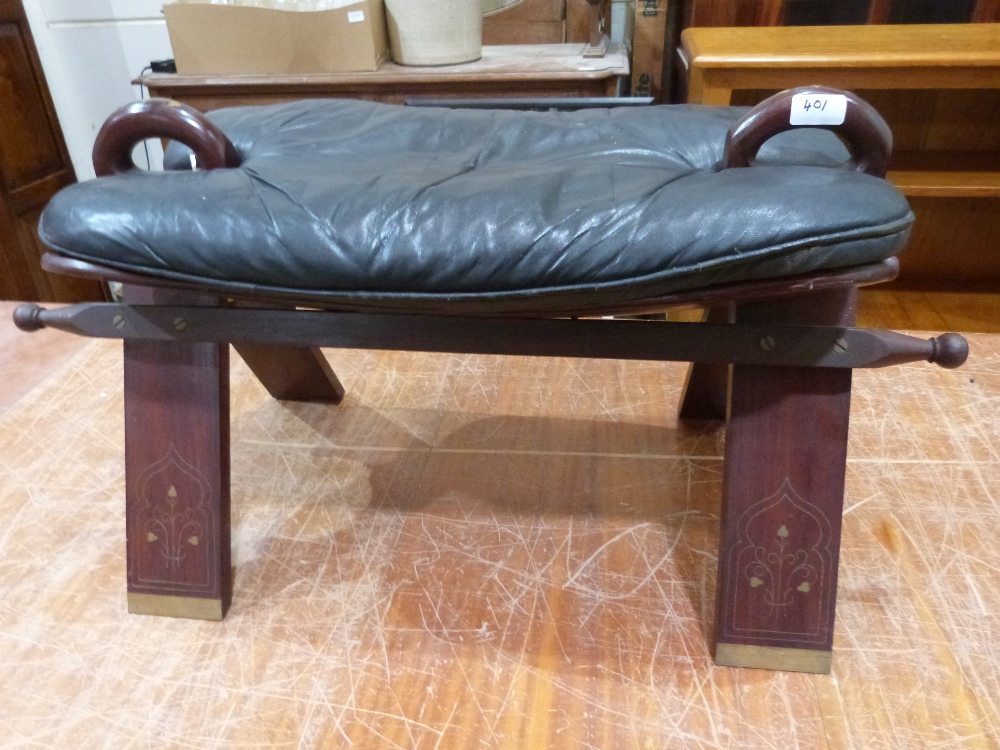 A brass inlaid saddle stool