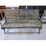 A cast iron and wood slatted garden seat. 62' wide