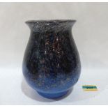 An art-glass vase, mottled in shades of black and blue with aventurine inclusions. Probably Monart