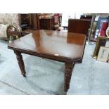A Victorian dining table on turned legs, extending to 58' with one extra leaf
