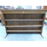 An oak breakfront dresser with raised rack