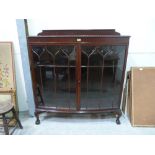 A 1920s mahogany bowfronted china display cabinet on cabriole legs. 48' wide