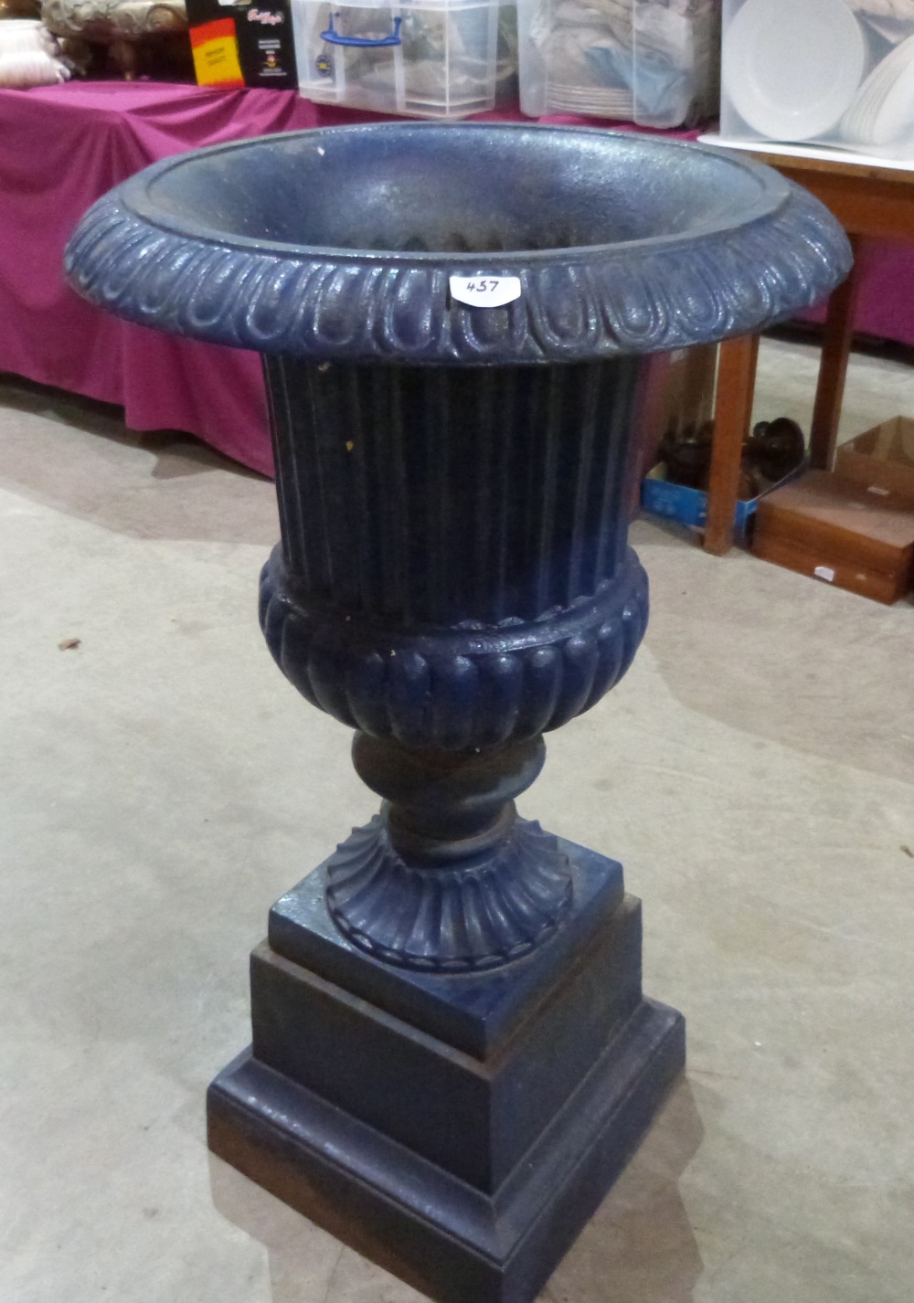 An early 20th century cast iron campana garden urn on stepped square socle base. 39' high