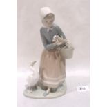 A Lladro figure of a goose girl. 9' high