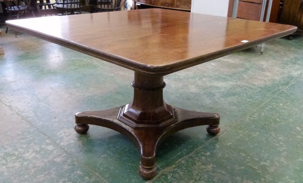 An early Victorian mahogany supper table, the top on turned and facetted column, on quadripartite