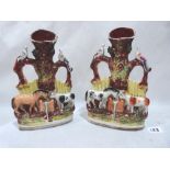 A pair of 19th century Staffordshire spill vases, moulded with a horse and cow drinking from a water