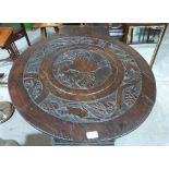 An oak carved lazy Susan, the base carved with dates and names. 29" diam. Prov: Made by students at