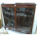 A 1920s mahogany bowfronted china display cabinet on cabriole legs. 48' wide. (One glass pane