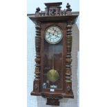 A walnut Vienna wall clock with two train movement striking on a coiled gong. 43' high