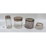 Three silver topped glass dressing table jars and a silver rimmed glass salt