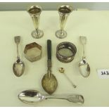 A pair of small silver trumpet vases, three silver teapsoons, two silver napkin rings, a silver