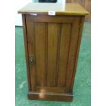 A Victorian walnut pot cupboard enclosed by a channel moulded door
