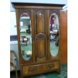 An Edward VII walnut wardrobe enclosed by a pair of mirror doors over a base drawer. 48' wide. One