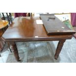 A Victorian dining table on turned legs, extending to 58' with one extra leaf