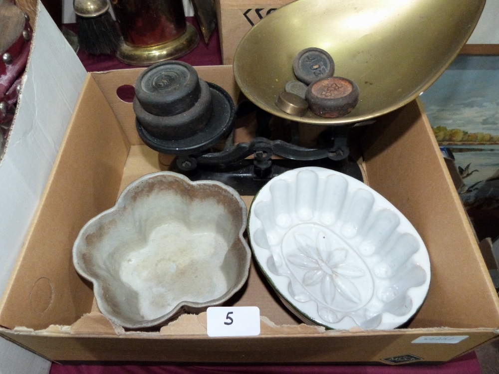 A set of weighing scales and two ceramic moulds