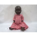An early 20th century Armand Marseille black baby doll, the porcelain head with sleeping eyes and