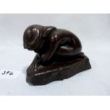 A bronze figure of a crouched girl signed D.J. Stockwell. 5' long