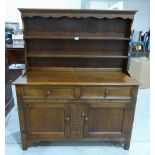 An oak dresser with raised rack. 50' wide