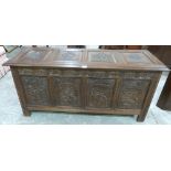 A joined oak carved four panel chest of recent manufacture. 55' wide