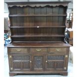 An oak carved dresser of recent manufacture with raised rack. 62' wide