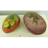 An early 20th century easter egg in painted and silk covered case on gilt ball feet. 7' long, with